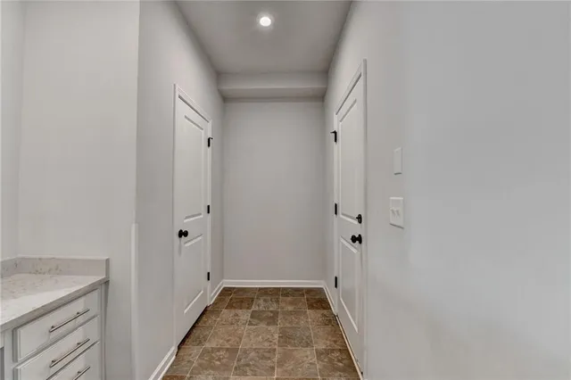a living room with stainless steel appliances kitchen island granite countertop a wooden floor