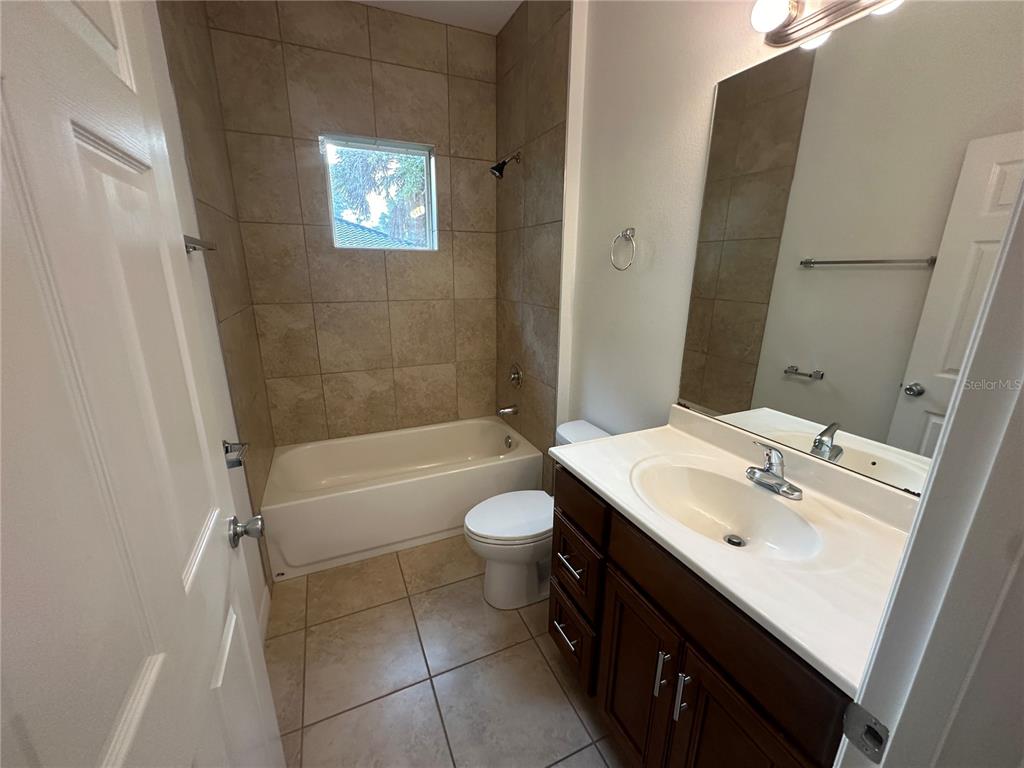 45 Prosperity Lane, Unit A Palm Coast, FL 32164 - Photo 8 of 10 a bathroom with a sink a toilet and shower