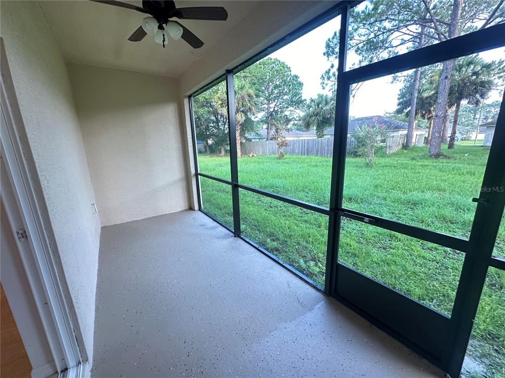 45 Prosperity Lane, Unit A Palm Coast, FL 32164 - Photo 9 of 10 a view of backyard with large trees and plants