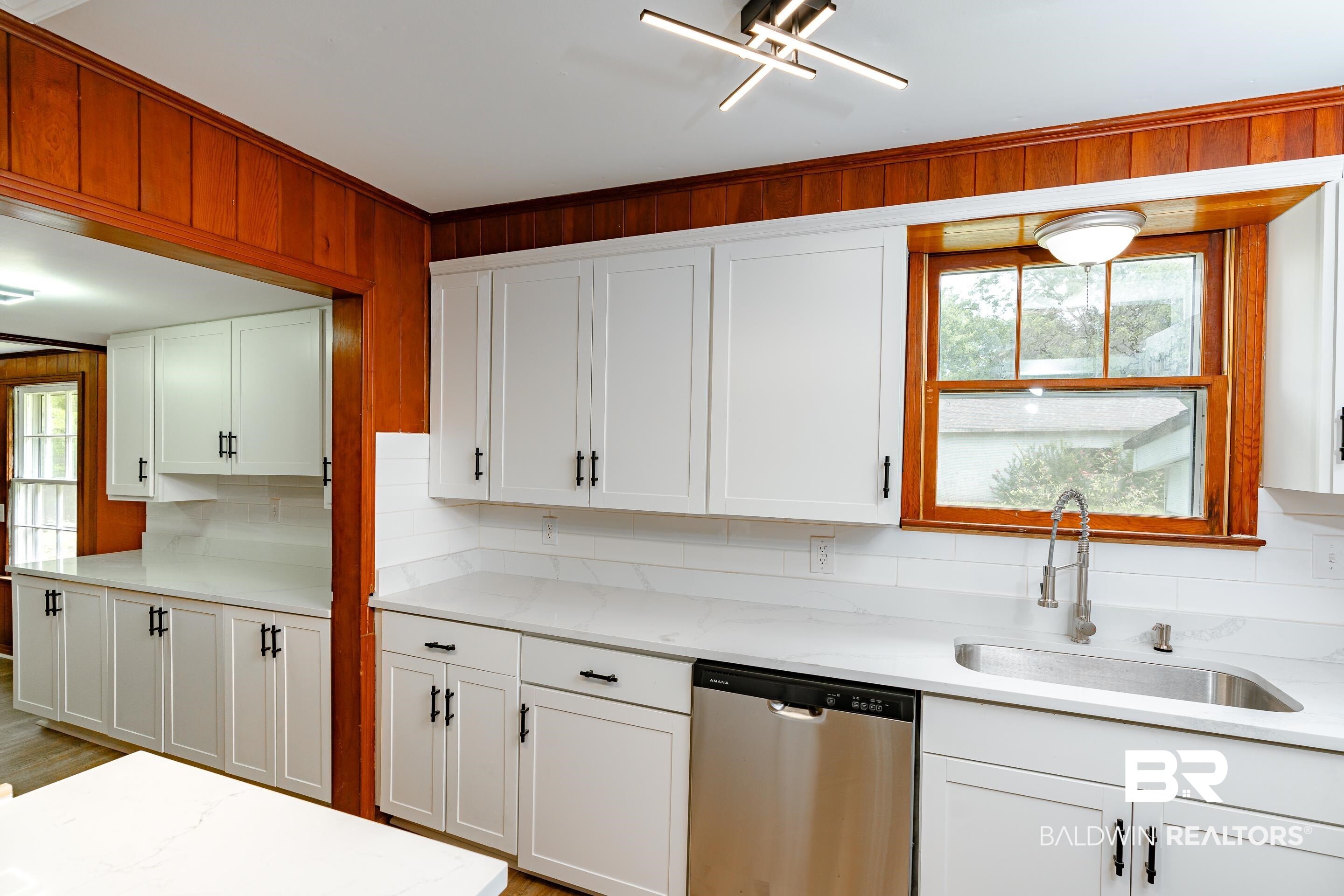 1160 Military Road Mount Vernon, AL 36560 - Photo 9 of 30 Kitchen with light hardwood / wood-style floors, stainless steel dishwasher, a wealth of natural light, and decorative backsplash