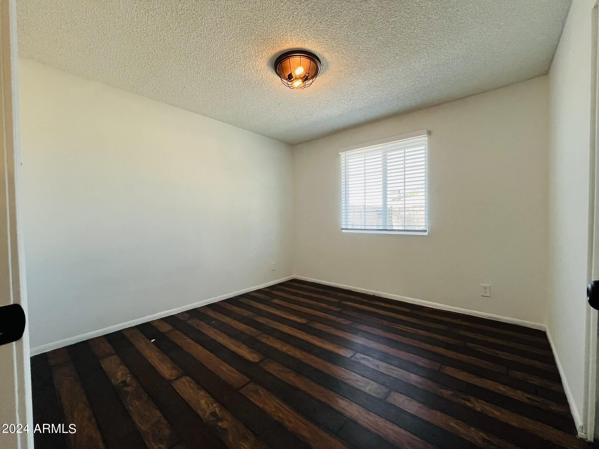 5154 West Berkeley Road Phoenix, AZ 85035 - Photo 11 of 19 a view of an empty room and window