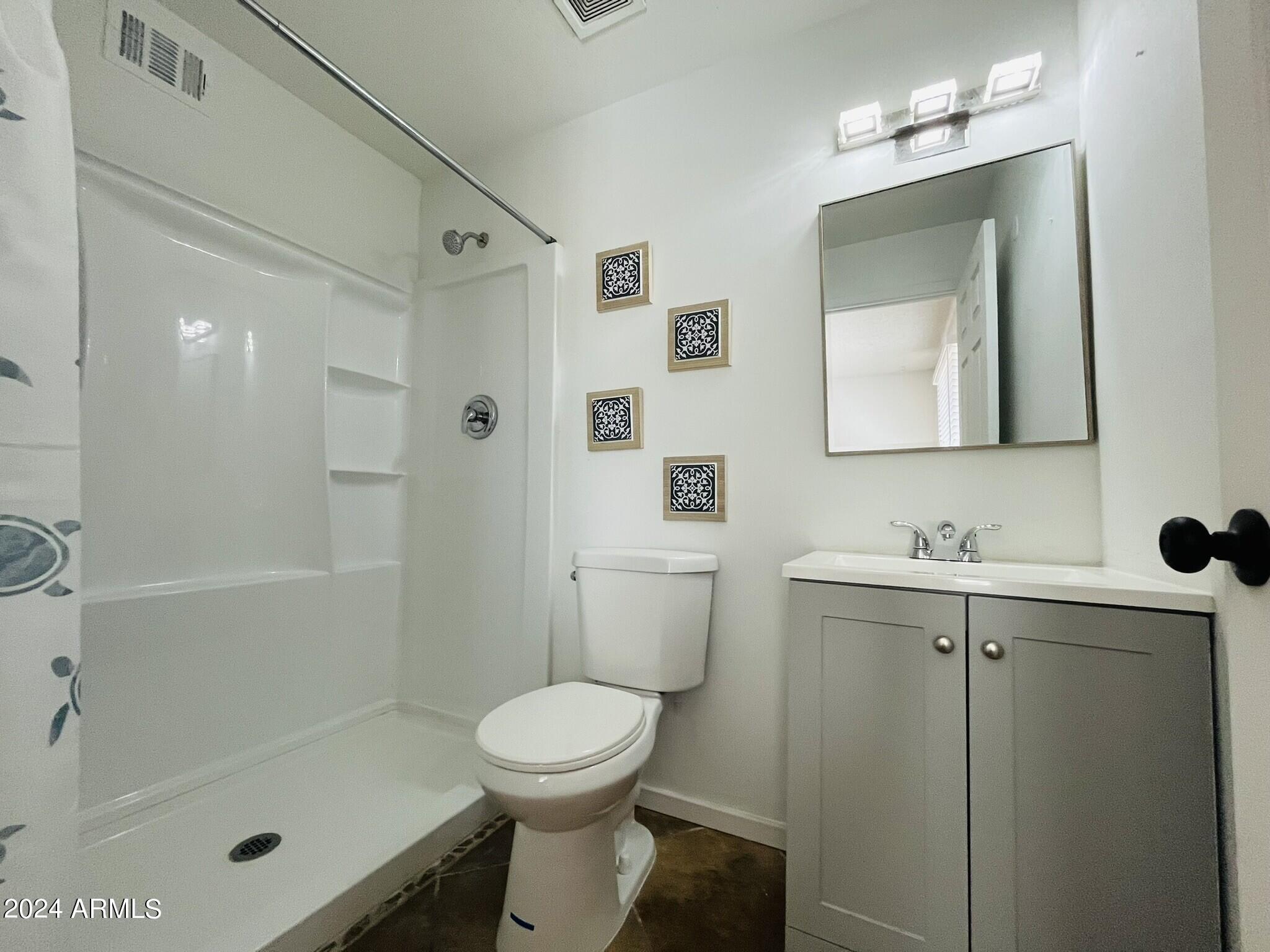 5154 West Berkeley Road Phoenix, AZ 85035 - Photo 14 of 19 a bathroom with a toilet sink and shower