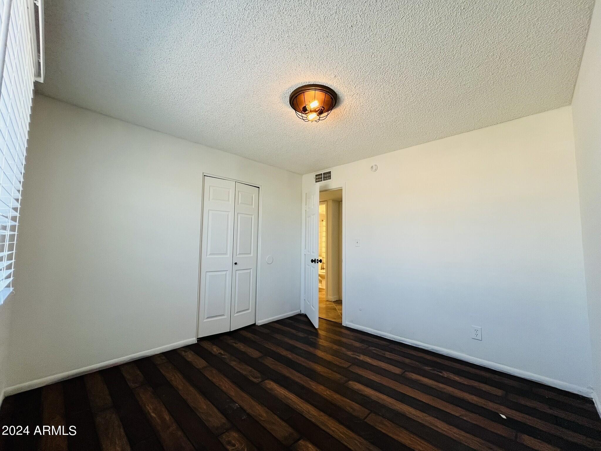 5154 West Berkeley Road Phoenix, AZ 85035 - Photo 15 of 19 a view of room with wooden floor