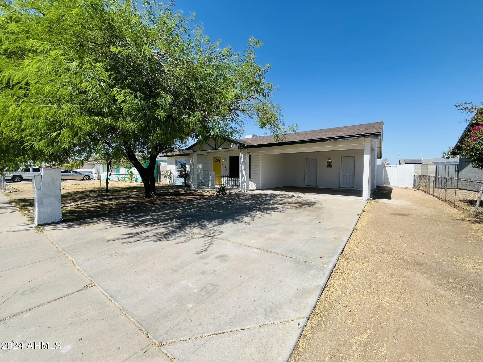 5154 West Berkeley Road Phoenix, AZ 85035 - Photo 19 of 19 a front view of a house with a yard