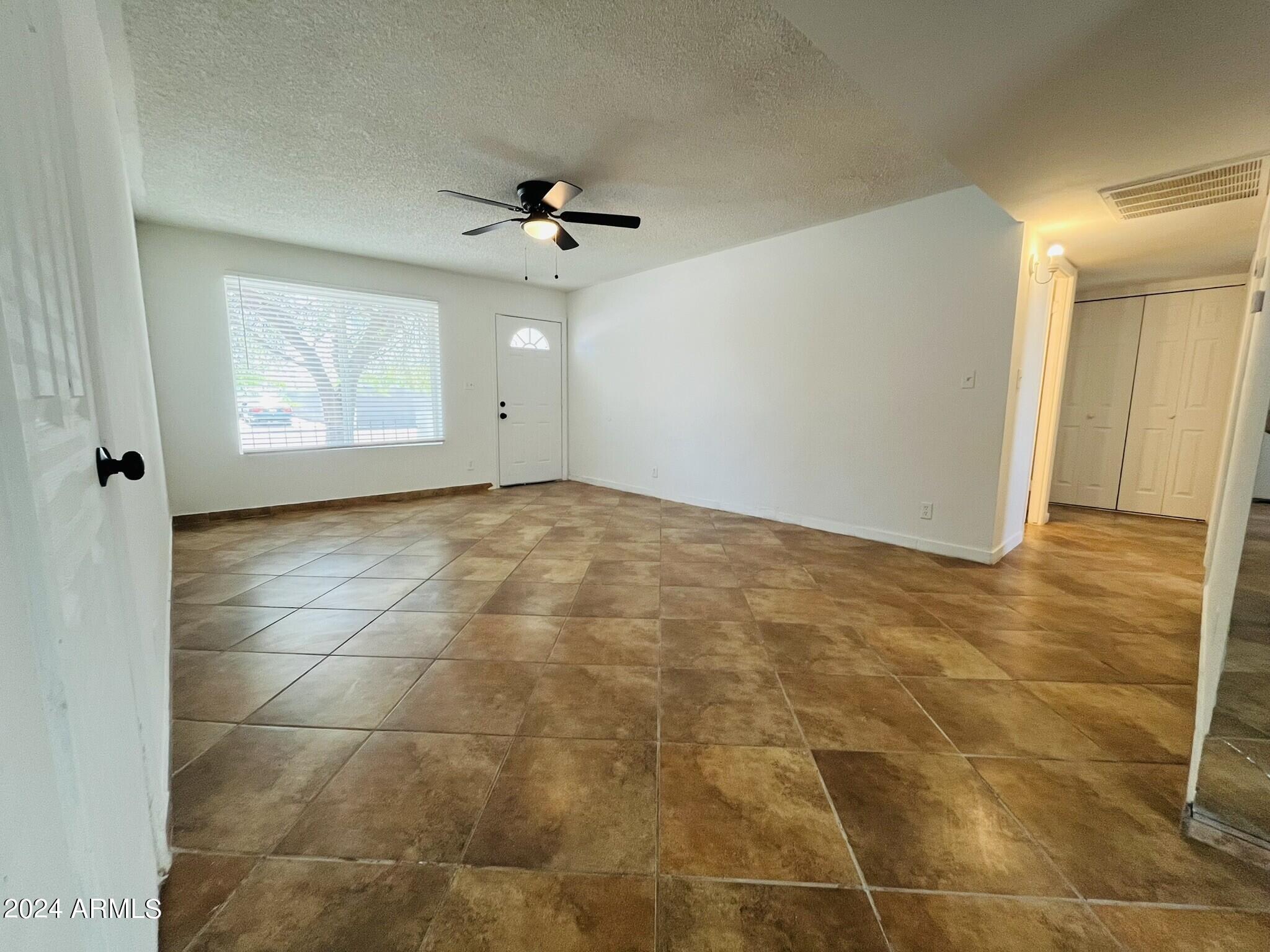 5154 West Berkeley Road Phoenix, AZ 85035 - Photo 3 of 19 a view of an empty room and a window