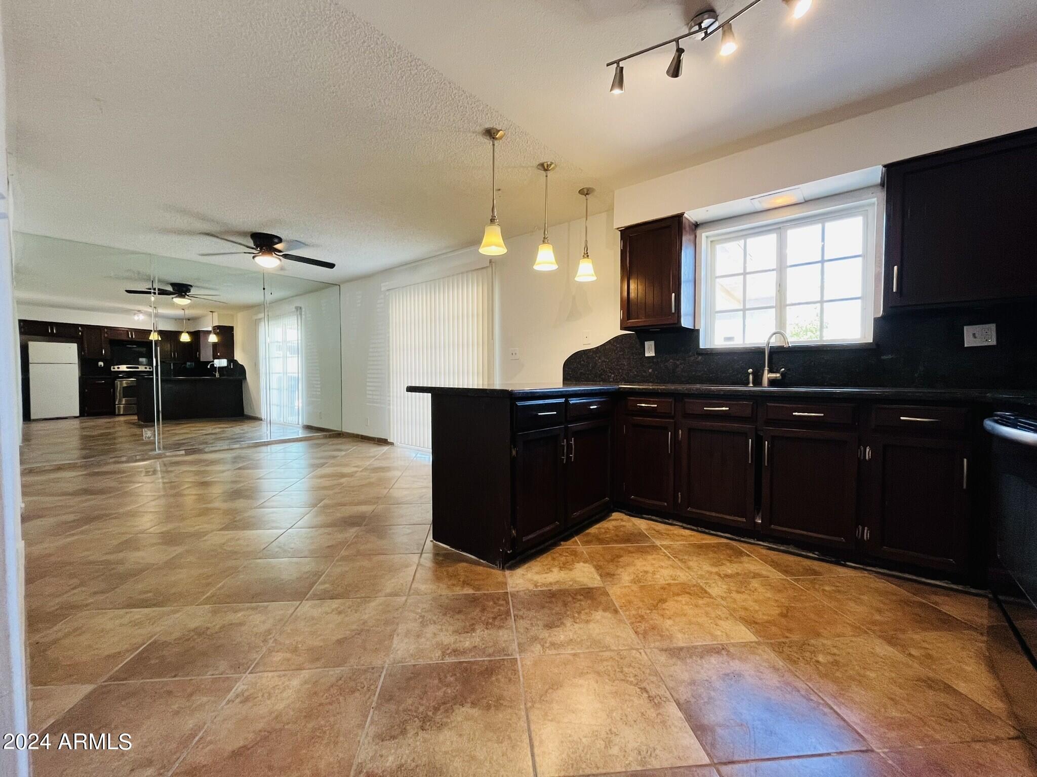 5154 West Berkeley Road Phoenix, AZ 85035 - Photo 5 of 19 a kitchen with a sink and cabinets
