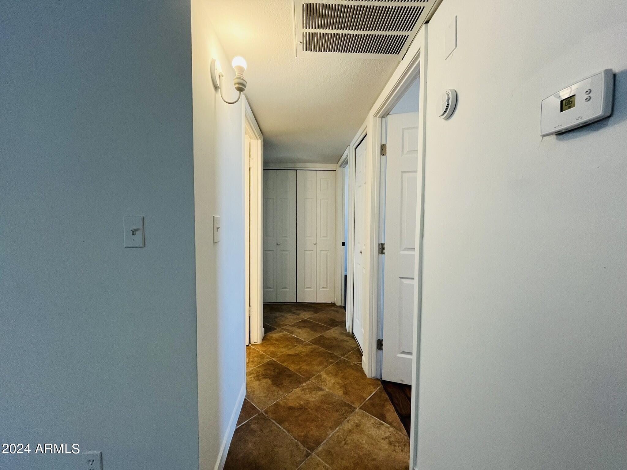 5154 West Berkeley Road Phoenix, AZ 85035 - Photo 7 of 19 a view of a hallway with white walls