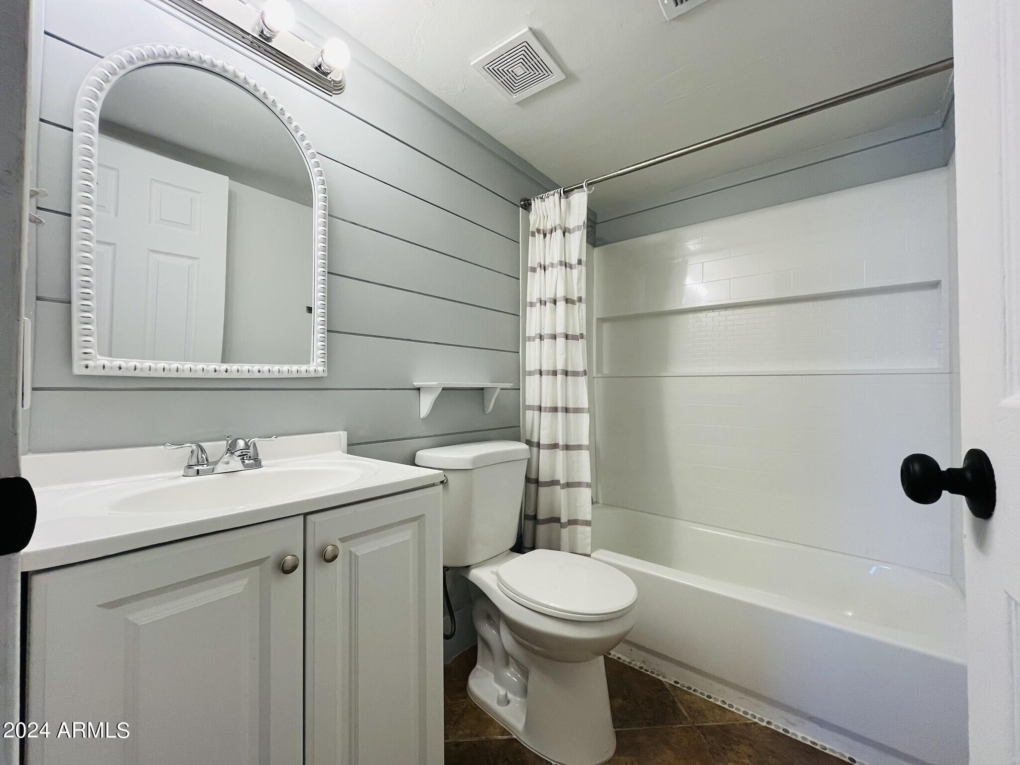 5154 West Berkeley Road Phoenix, AZ 85035 - Photo 8 of 19 a bathroom with a sink a toilet and shower