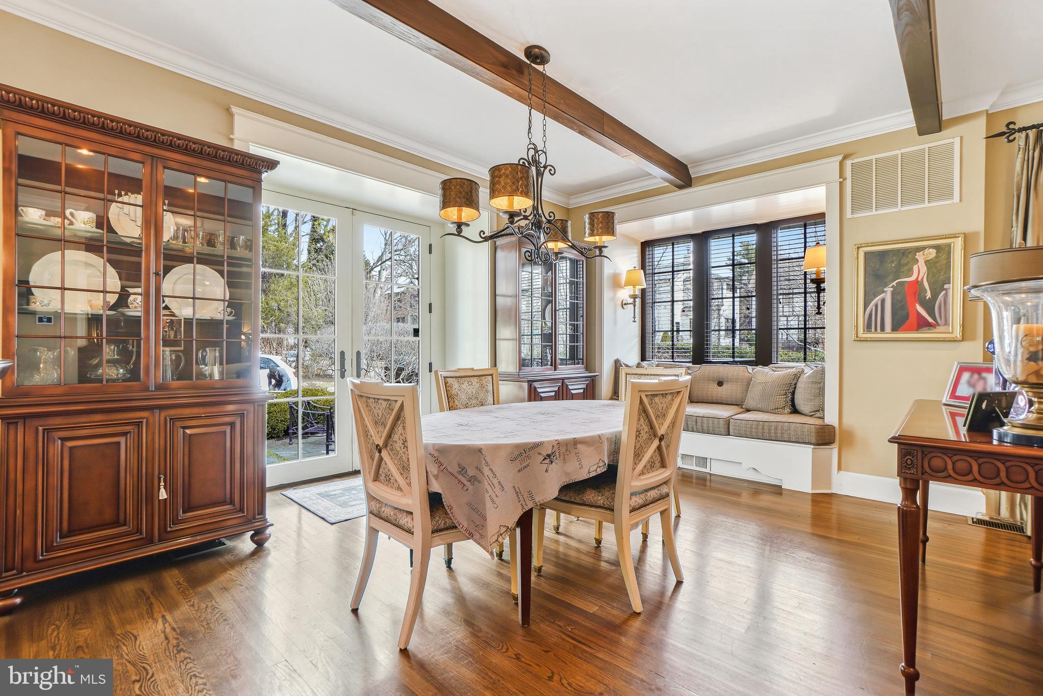 4201 Military Road Northwest Washington, DC 20015 - Photo 7 of 49 a dining room with wooden floor a chandelier a glass table and chairs