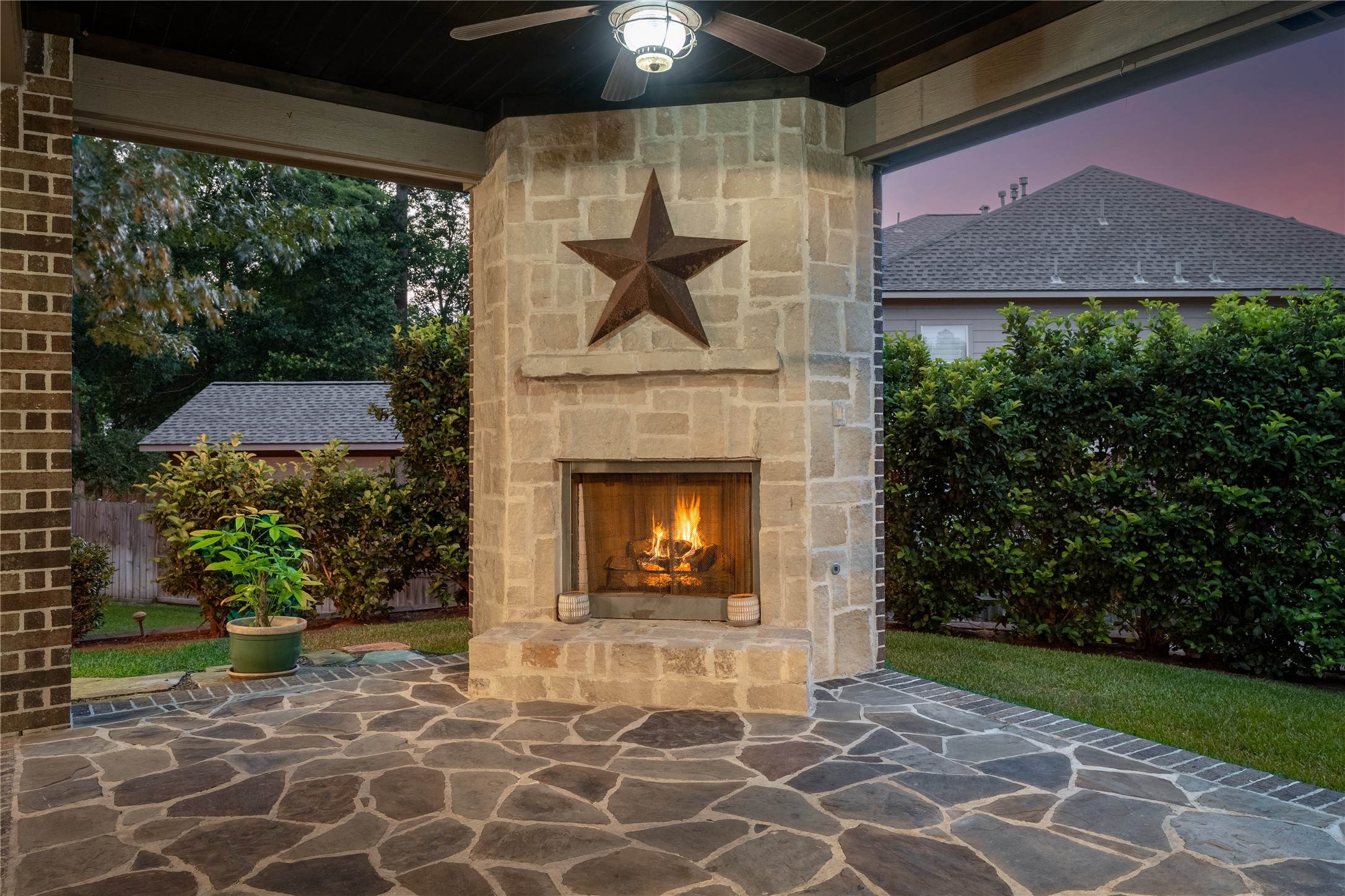 2115 Graystone Ridge Drive Conroe, TX 77304 - Photo 39 of 47 Spacious outdoor patio with a cozy fireplace