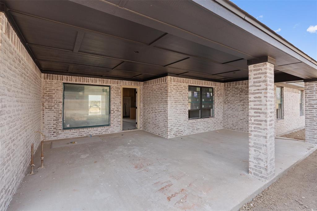 1300 Promised Land Road Hewitt, TX 76643 - Photo 12 of 34 Covered patio with a paneled ceiling, light-toned brick exterior, and a large fixed window