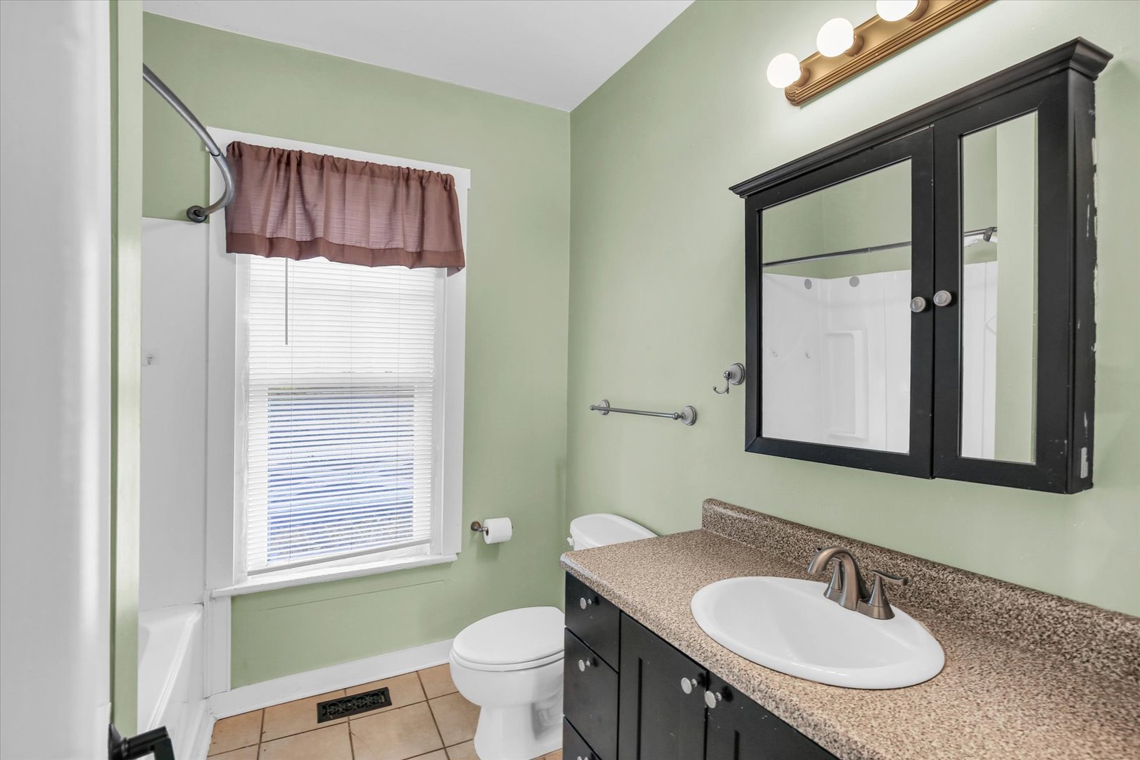 107 Byron Street Sidney, IL 61877 - Photo 19 of 31 a bathroom with a sink a toilet and a mirror