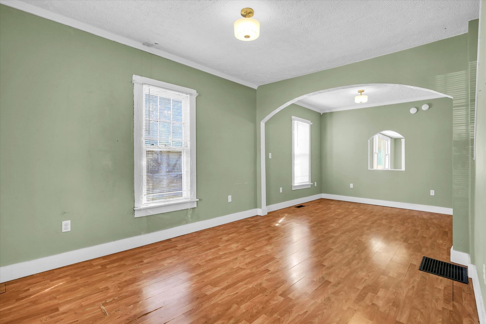 107 Byron Street Sidney, IL 61877 - Photo 8 of 31 a view of an empty room with wooden floor and a window