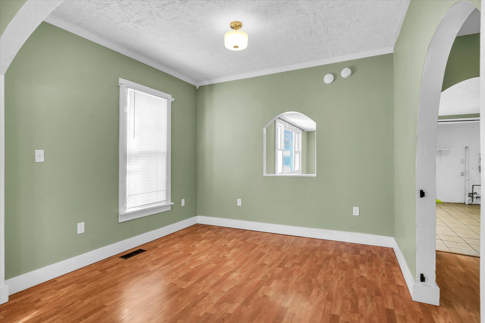 107 Byron Street Sidney, IL 61877 - Photo 9 of 31 a view of empty room with window and wooden floor