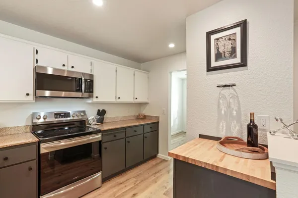 a kitchen with stainless steel appliances granite countertop a sink stove and refrigerator