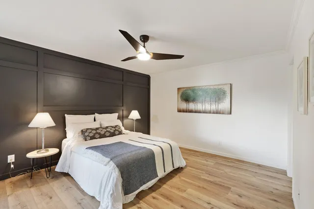 a bedroom with a bed and a lamp