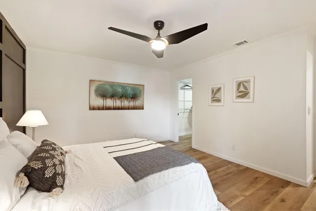 a bedroom with a bed and a lamp