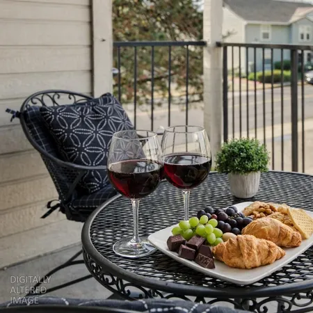 a table with wine bottles and glass of wine on table
