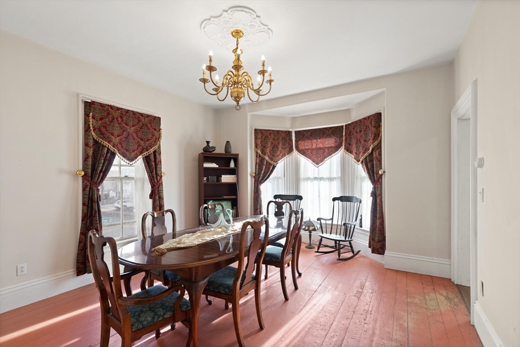 118 Prospect Street Gloucester, MA 01930 - Photo 12 of 36 a view of a dining room with furniture wooden floor and chandelier