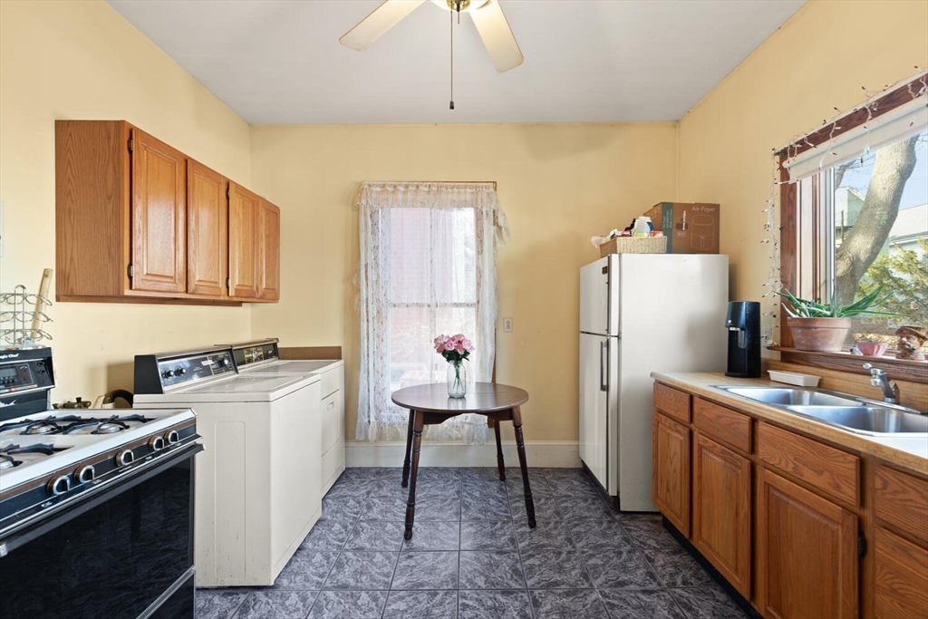 118 Prospect Street Gloucester, MA 01930 - Photo 14 of 36 a kitchen with a sink stove and refrigerator