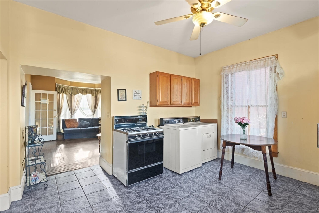 118 Prospect Street Gloucester, MA 01930 - Photo 15 of 36 a kitchen with a stove a refrigerator and a sink