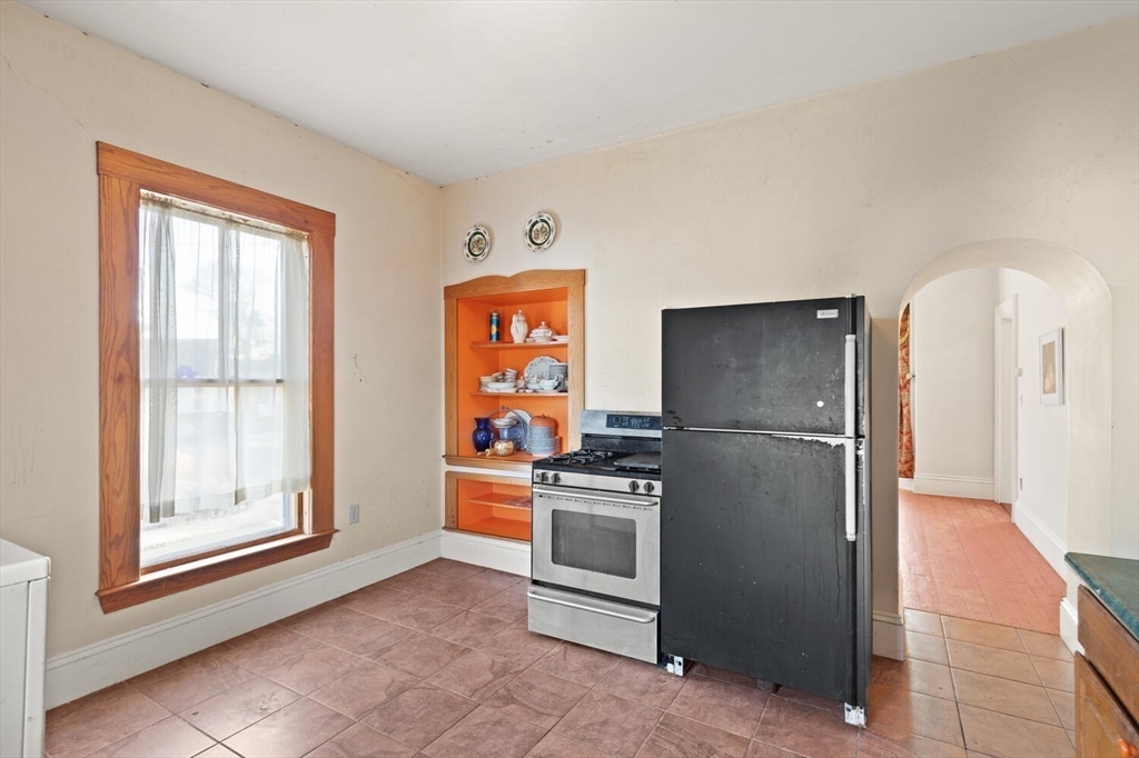 118 Prospect Street Gloucester, MA 01930 - Photo 16 of 36 a kitchen with stainless steel appliances a refrigerator and a stove