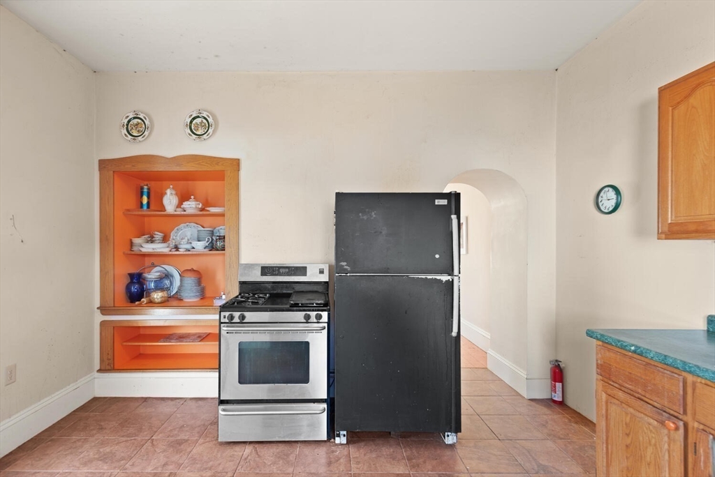 118 Prospect Street Gloucester, MA 01930 - Photo 17 of 36 a kitchen with stainless steel appliances granite countertop a refrigerator and a stove