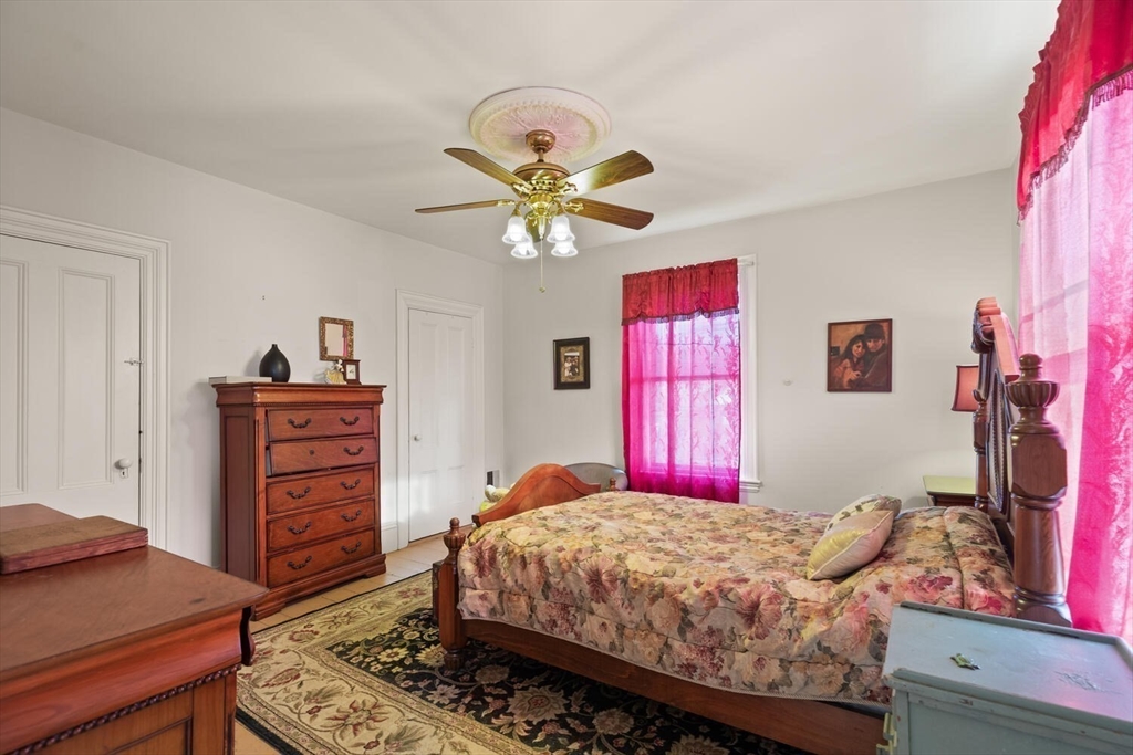 118 Prospect Street Gloucester, MA 01930 - Photo 25 of 36 a bedroom with a bed and a dresser in it
