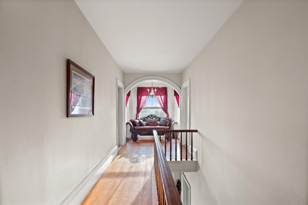 118 Prospect Street Gloucester, MA 01930 - Photo 6 of 36 a view of a hallway with a flower pot