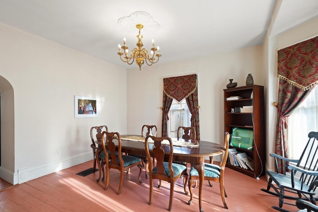 118 Prospect Street Gloucester, MA 01930 - Photo 10 of 36 a view of a dining room with furniture and chandelier