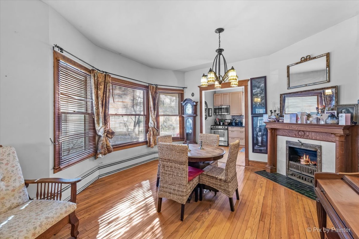 84 Kimbark Road Riverside, IL 60546 - Photo 7 of 40 a dining room with furniture wooden floor a rug a fireplace and a chandelier