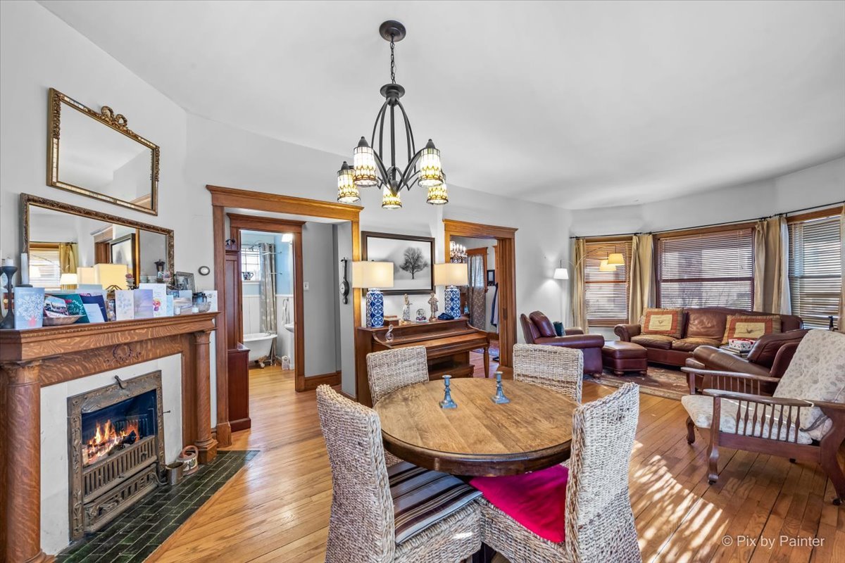 84 Kimbark Road Riverside, IL 60546 - Photo 9 of 40 a living room with furniture a fireplace and a chandelier