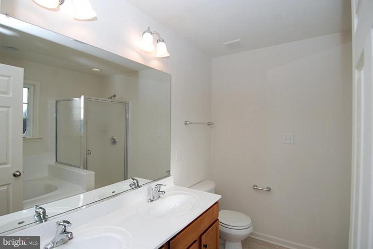 74 Shelby Road Inwood, WV 25428 - Photo 16 of 27 a bathroom with a sink a toilet and shower