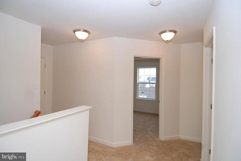 74 Shelby Road Inwood, WV 25428 - Photo 20 of 27 a view of an empty room with wooden floor and cabinets