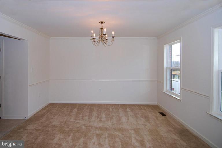 74 Shelby Road Inwood, WV 25428 - Photo 5 of 27 wooden floor in an empty room with a window