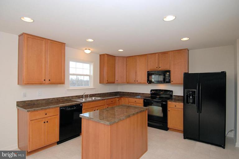 74 Shelby Road Inwood, WV 25428 - Photo 10 of 27 a kitchen with stainless steel appliances granite countertop a stove a refrigerator and a sink