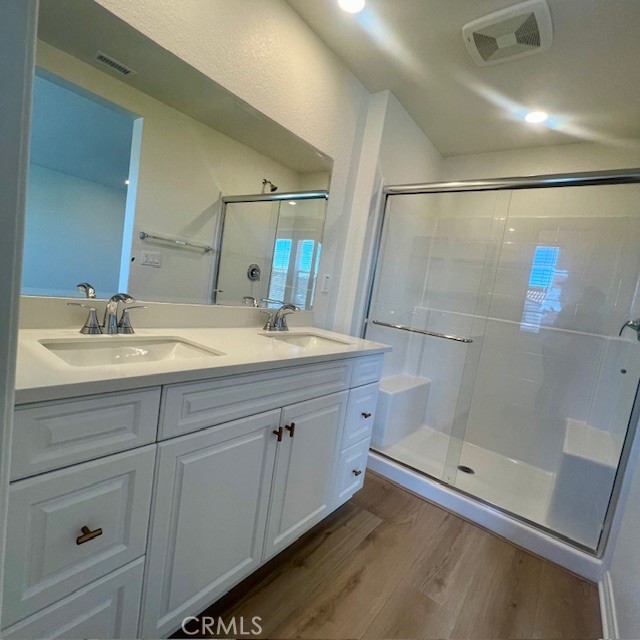 4235 East Rincon Street Ontario, CA 91761 - Photo 18 of 40 a bathroom with a double vanity sink a mirror and shower