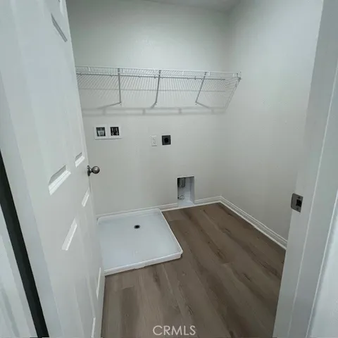 an empty room with closet and windows