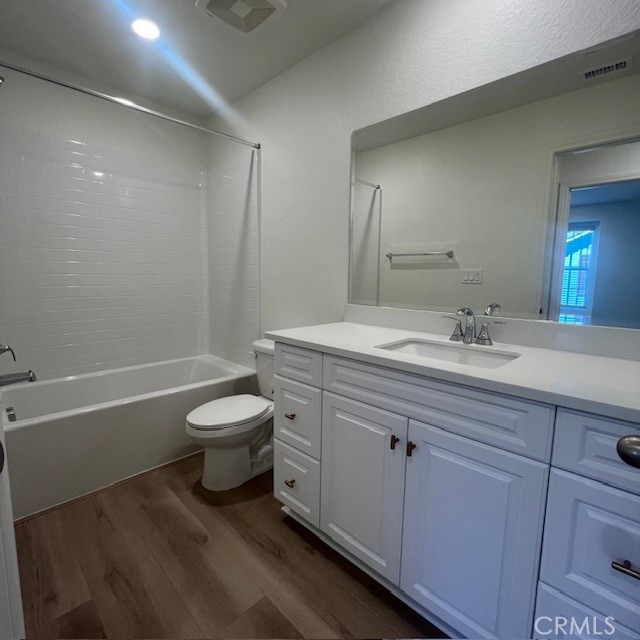4235 East Rincon Street Ontario, CA 91761 - Photo 26 of 40 a bathroom with a granite countertop toilet a sink and a bathtub