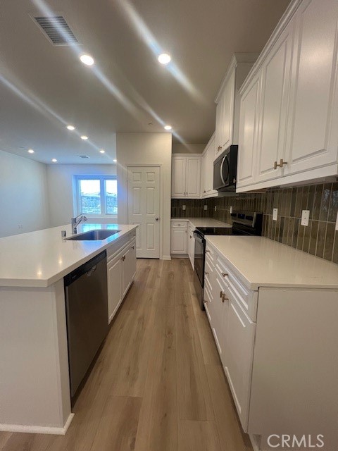 4235 East Rincon Street Ontario, CA 91761 - Photo 4 of 40 a kitchen with granite countertop a sink a counter space stainless steel appliances and cabinets