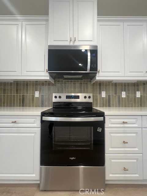 4235 East Rincon Street Ontario, CA 91761 - Photo 5 of 40 a kitchen with stainless steel appliances granite countertop a stove and a microwave