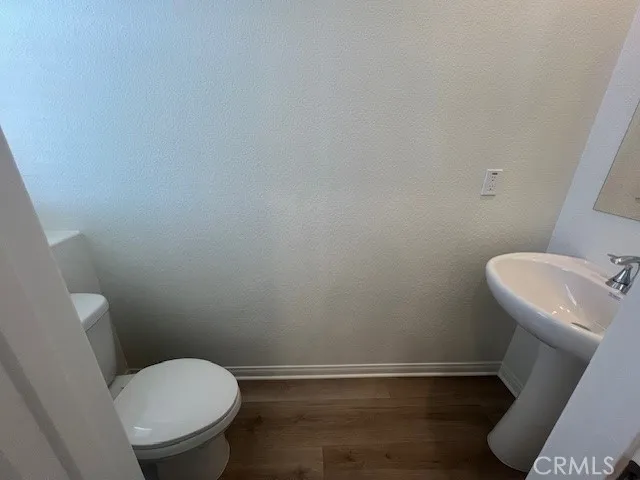 a white toilet sitting next to a small sink