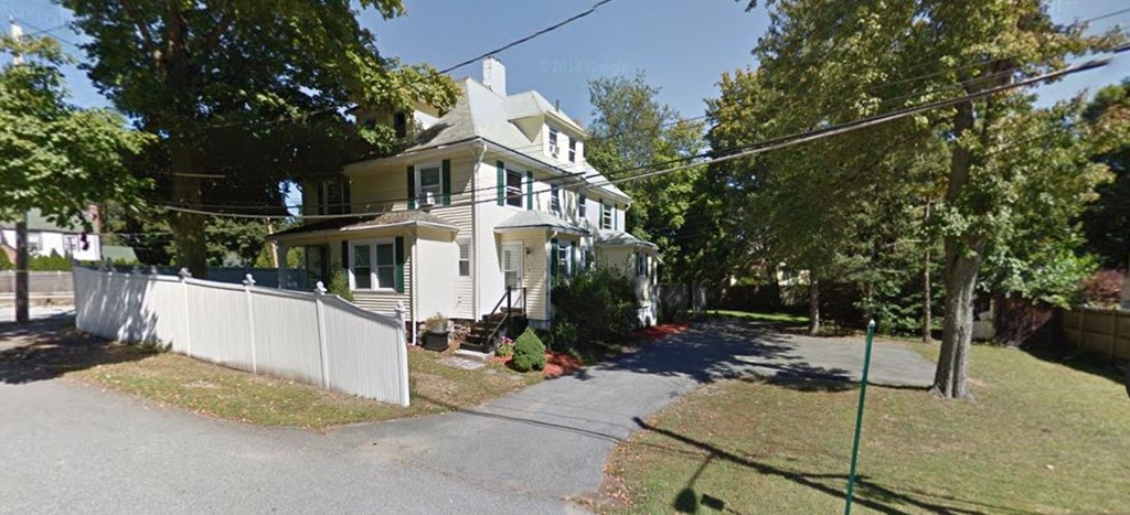 2 Francis Road Wellesley, MA 02482 - Photo 1 of 6 a view of a white house with a iron fence