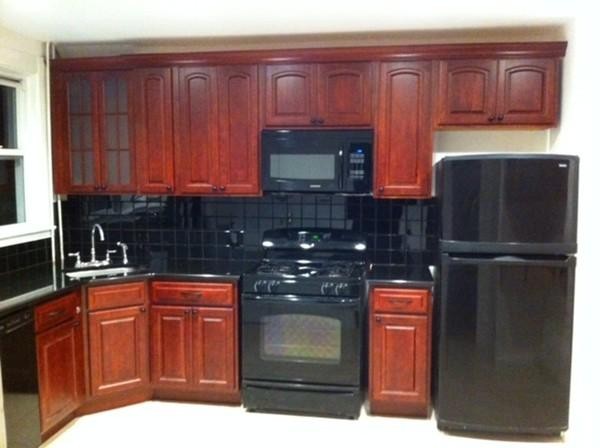 2 Francis Road Wellesley, MA 02482 - Photo 2 of 6 a kitchen with stainless steel appliances granite countertop wooden cabinets a refrigerator and sink