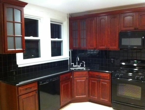 2 Francis Road Wellesley, MA 02482 - Photo 4 of 6 a kitchen with wooden cabinets and a sink