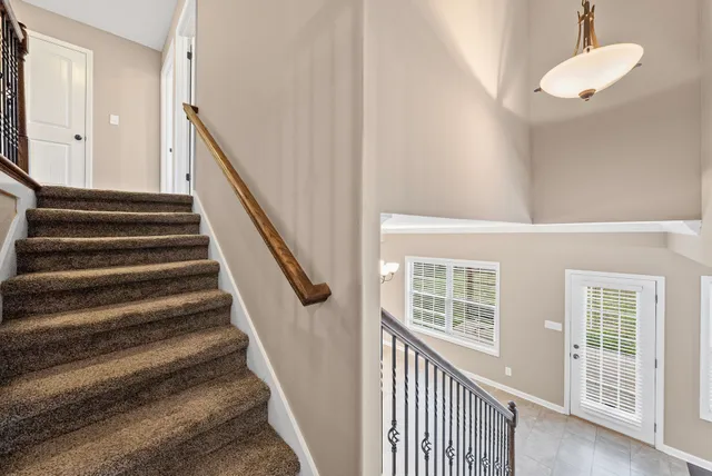 a view of a stairs and wooden floor