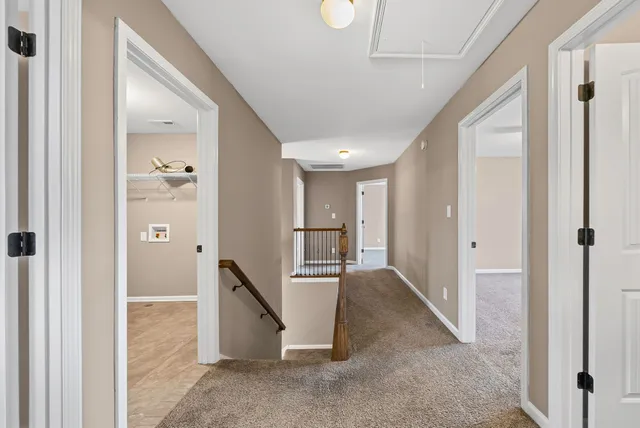 a view of a hallway with windows and entryway