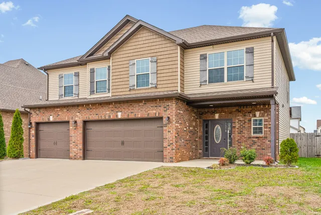 a front view of a house with a yard and garage