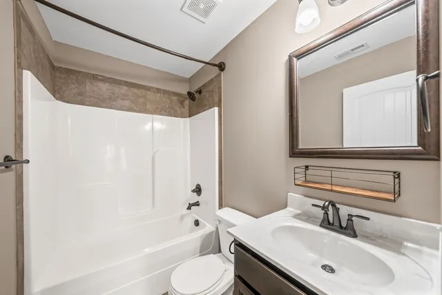 an empty room with a window and a ceiling fan