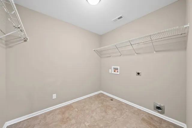 a view of a patio with a table and chairs